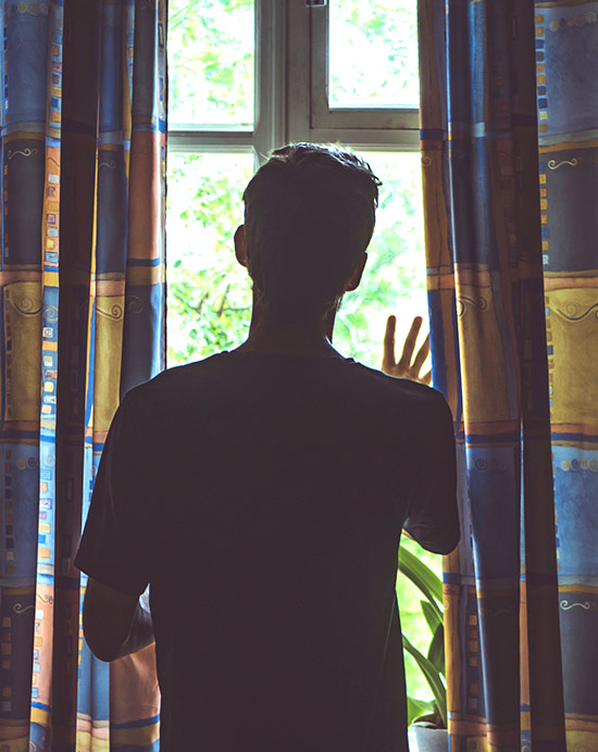 Man-Staring-Out-Window