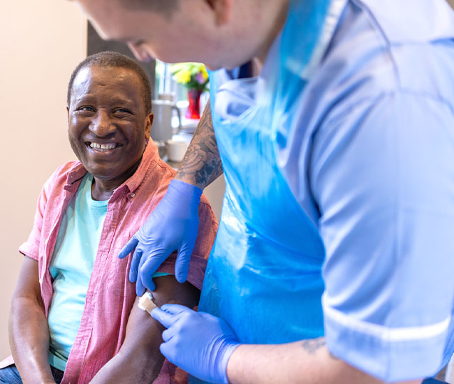 A medical professional helping a patient